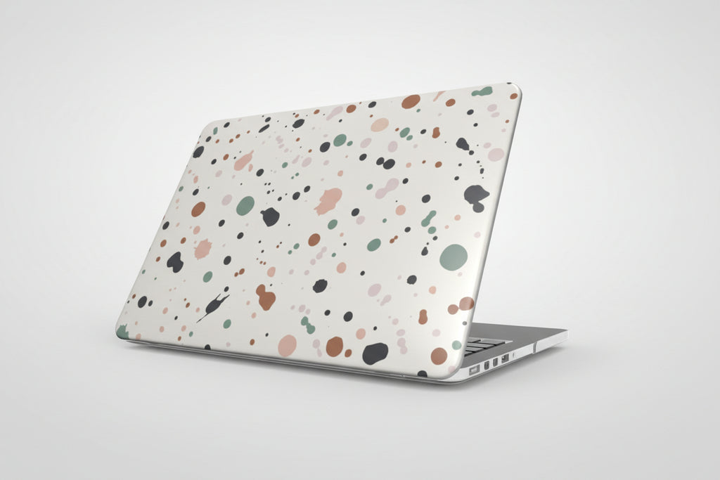 Laptop with a multicolored speckled case on a white background