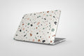 Laptop with a multicolored speckled case on a white background