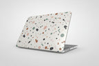 Laptop with a multicolored speckled case on a white background