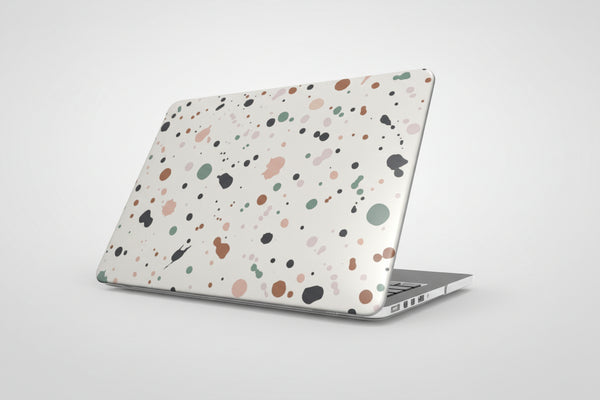 Laptop with a multicolored speckled case on a white background