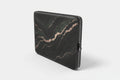 Black marble-patterned laptop sleeve on a white background