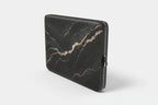Black marble-patterned laptop sleeve on a white background