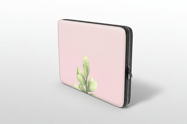 Pink laptop sleeve with green leaf design on a white background